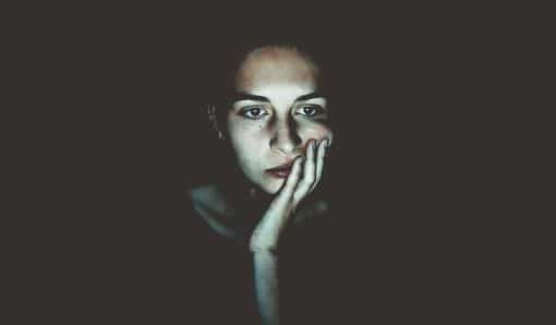 Woman's face illuminated by screen