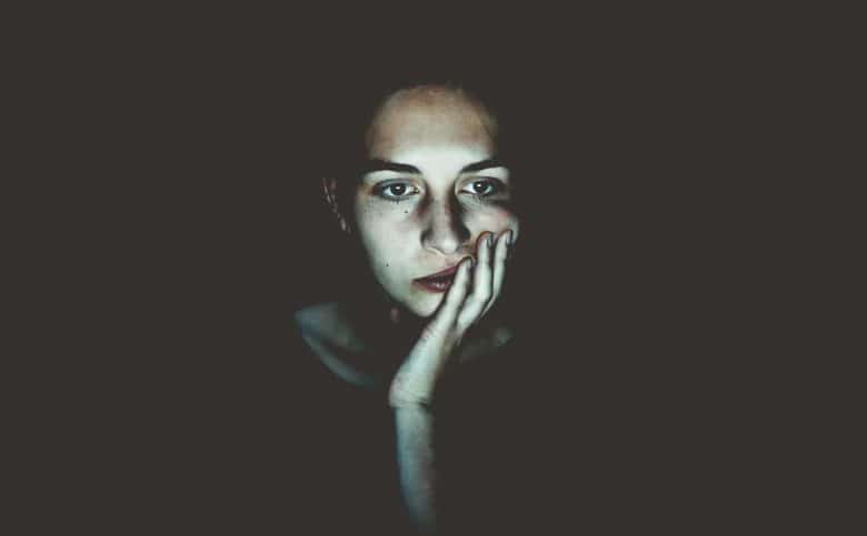 Woman's face illuminated by screen